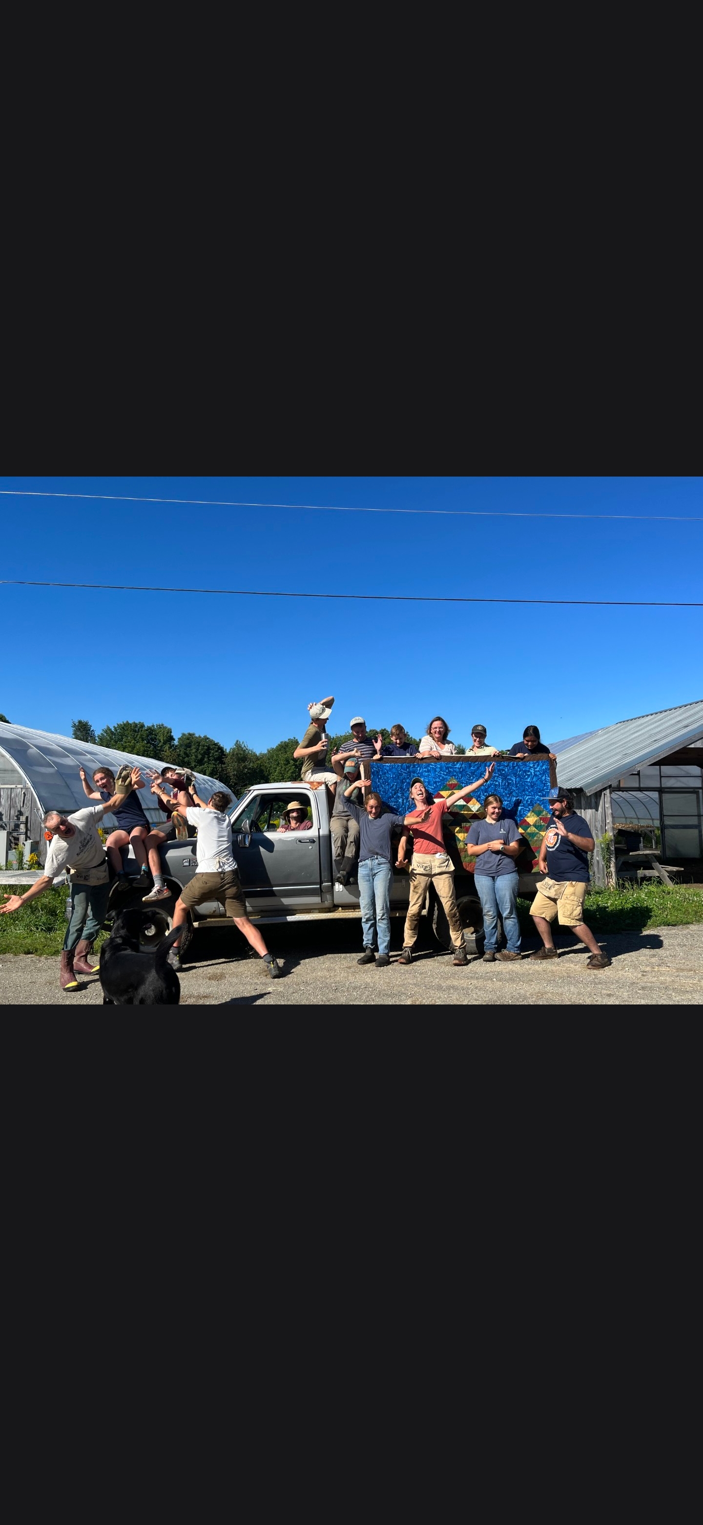 Farm crew gathered around a pickup truck